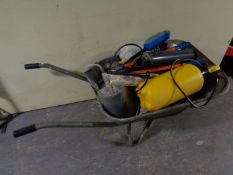 A wheelbarrow containing garden sprayers,