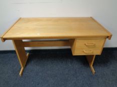 A pine desk fitted two drawers
