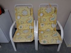 Four metal stacking garden armchairs with cushions