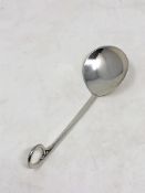 An Arts and Craft style silver spoon by A E Jones with a split ring and bead terminal.