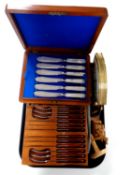 A tray containing an Edwardian canteen of fish cutlery together with a set of teak handled cutlery,