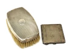 A silver compact with engine turned decoration,