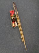 A bundle of snooker cues together with a tin and as box containing snooker balls