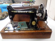 An early 20th century oak cased Singer hand sewing machine