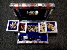 An Eastern style trinket box in the form of a book containing a quantity of costume jewellery