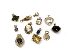 Twelve 9ct gold pendants. CONDITION REPORT: 22.