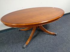 A Bradley Furniture reproduction oval yew wood pedestal coffee table