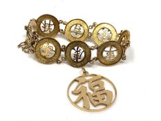 An oriental gold bracelet and a similar pendant (each stamped '14kt' but not testing higher than