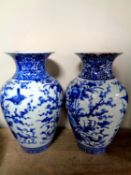 A pair of Chinese blue and white glazed ceramic vases depicting flowers, height 31.