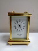 A brass cased Philip Morris eleven jewel carriage clock with key