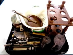 A tray of plated servers, copper and brass handled pans,