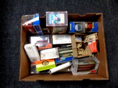 A box containing a quantity of boxed die cast vehicles to include Corgi trams and Parcel Force