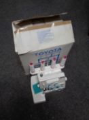 A Toyota SL Series differential over locking sewing machine in original box