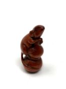 A carved hardwood netsuke - Rat climbing a spike