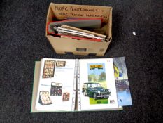 A box containing two folders containing late 20th century die cast car catalogues to include Corgi,
