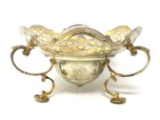 A good quality silver gilt pierced dish raised on shell pad feet