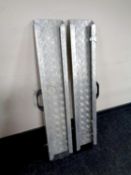 A pair of metal car access wheel chair ramps