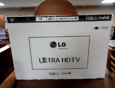 An LG 42UB820V Ultra HD Smart TV in original box with remotes