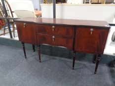 An inlaid mahogany Regency style sideboard on raised legs