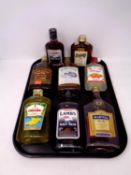 A tray containing eight bottles of alcohol to include Lamb's Navy Rum, Southern Comfort,