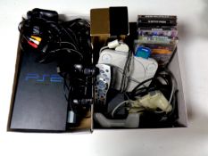 Two boxes containing PlayStation and PlayStation 2 consoles, leads and controllers,