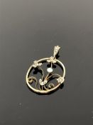 An antique 9ct gold pendant set with seed pearls