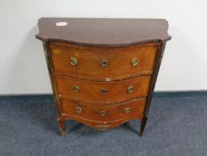 A Louis XIV French style inlaid serpentine fronted three drawer chest with marble top