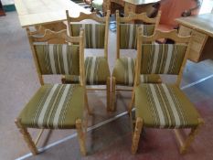 A set of five blonde oak dining chairs upholstered in a green striped fabric