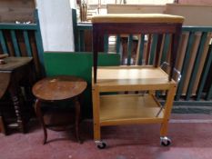 A 20th century two tier tea trolley together with a circular two tier occasional table,