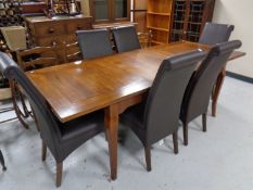 A contemporary extending dining table with leaf together with a set of six high backed leather