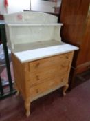 A stripped pine marble topped three drawer wash stand