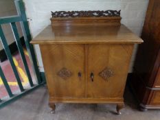 A continental oak double door cabinet on cabriole legs