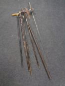 A bundle containing assorted walking sticks to include plated pommel examples, fencing foil,