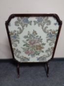 An antique mahogany and tapestry fire screen/table