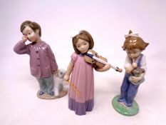 Three Nao figures, boy with teddy bear,