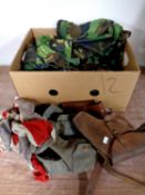 A box containing military clothing, leather holsters, belts,