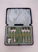 A set of six cased Birmingham silver teaspoons with matching sugar tongs dated 1900