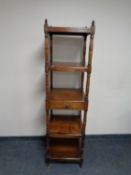 A Regency simulated rosewood five tier whatnot stand fitted a drawer