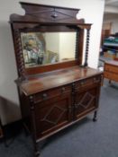 A 1930s oak barley twist mirror back sideboard