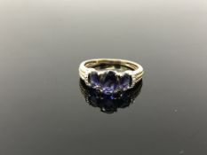 A 9ct gold dress ring set with diamond shoulders