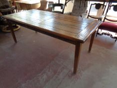 A contemporary hardwood pull out dining table fitted a leaf