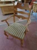 A blonde oak carver armchair