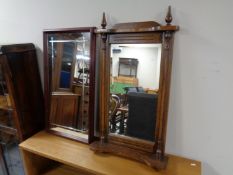 An oak framed bevel edged hall mirror with shelf and finials together with a further mahogany