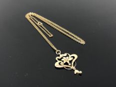 An antique 9ct gold pendant suspended on chain