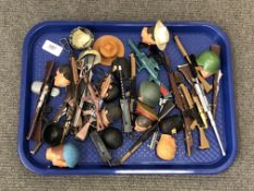 A tray of a quantity of action man heads,