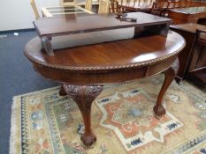 A Victorian mahogany oval-shaped wind-out dining table, with rope-effect edge,