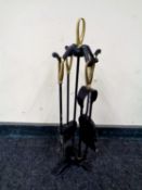 A four piece brass handled companion set on stand