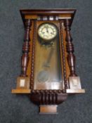 An Edwardian eight day wall clock with pendulum and key