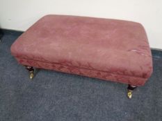 A Victorian style over sized footstool upholstered in a purple floral fabric (as found)