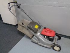 A Honda self drive petrol lawn mower with grass box